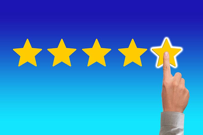 fivestars A hand selecting 5 stars, illustrating the need to respond to reviews online with a reputation management plan